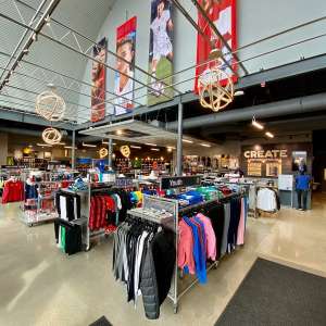 Inside Stefans Soccer store with clothing racks and large soccer pictures
