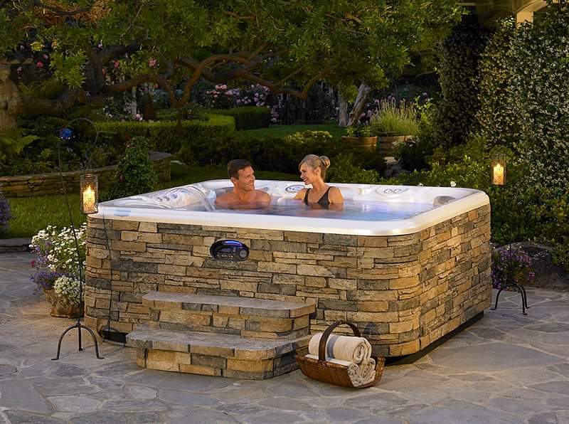 Man and Women sitting in a hot tub