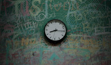 Clock on chalkboard