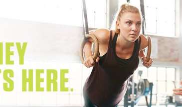 Woman working out with man helping