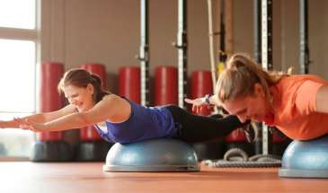 2 Woman laughing while working out