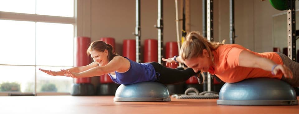 2 Woman laughing while working out