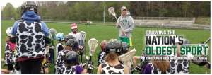 Man standing in front of children holding lacrosse stick